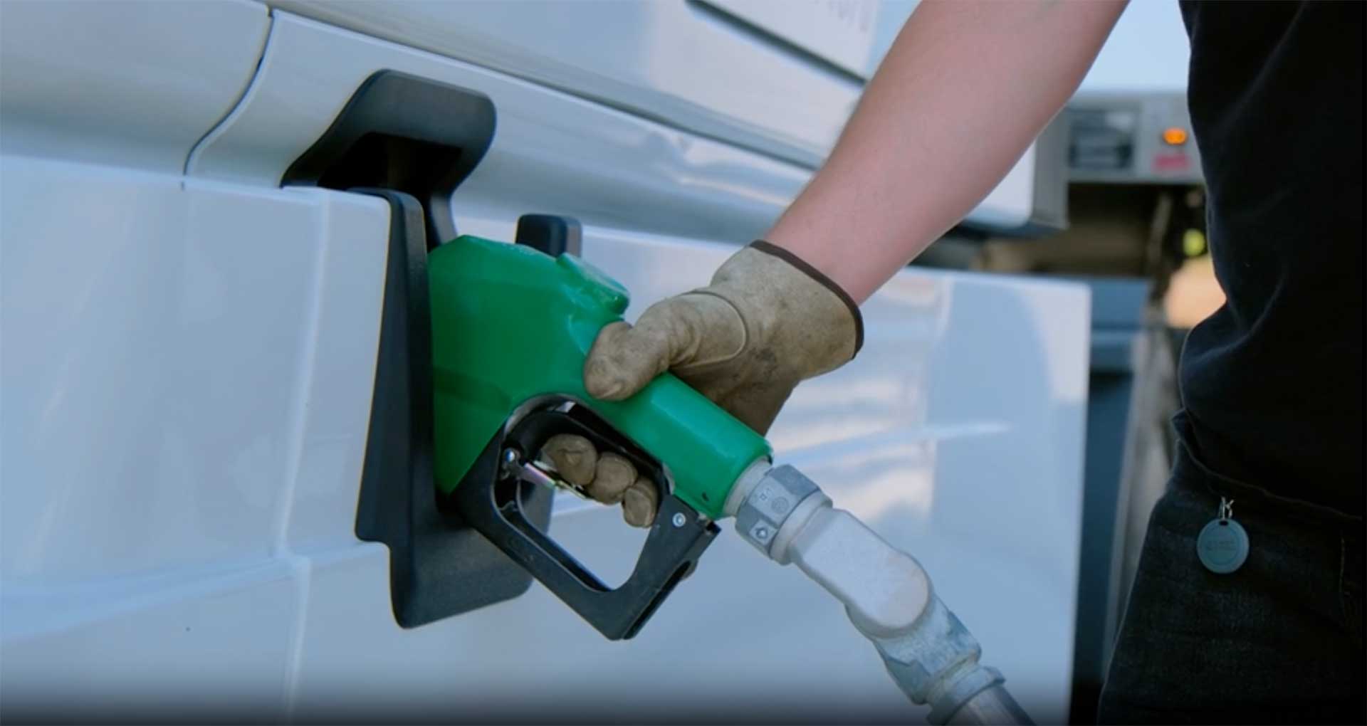 Hand holding a fuel pump nozzle