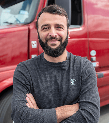 Carrier standing in front of red semi-truck